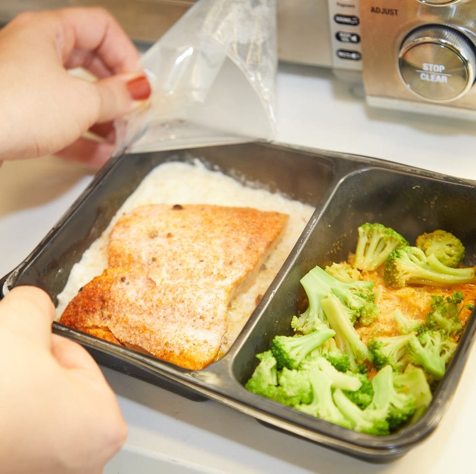 a person cutting a piece of bread