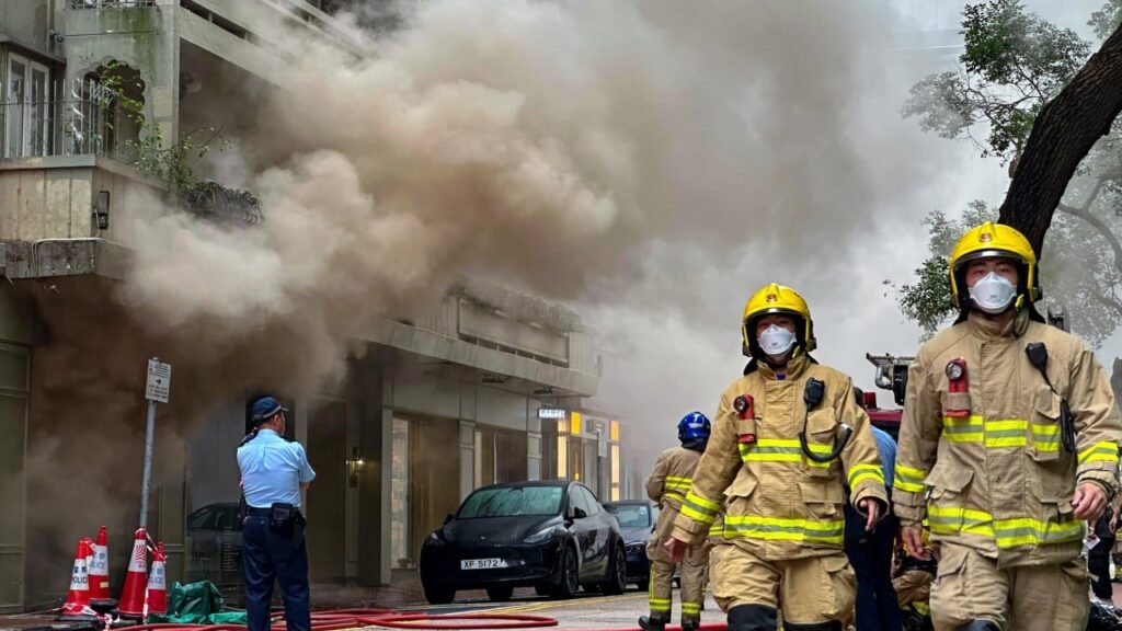 Fire erupts at busy Hong Kong shopping district, with smoke billowing into streets