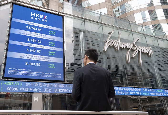An electronic screen and ticker at the Exchange Square Complex, which houses the Hong Kong Stock Exchange, on Feb. 26, 2025.