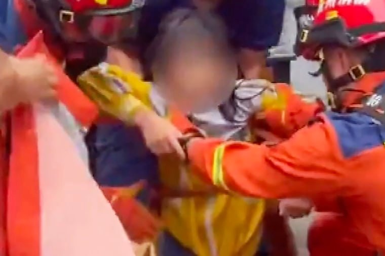 A girl in China is rescued from a storm drain after intense flash flooding.