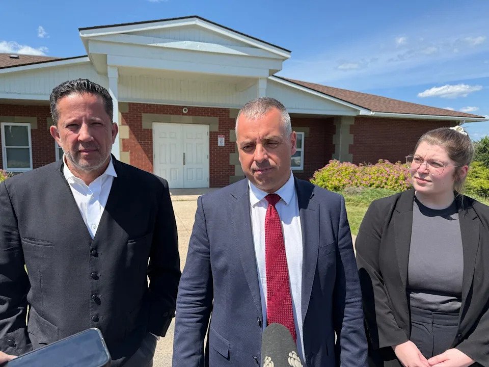 T.J. Burke, left, Nathan Gorham, and Erin Davies outside the Burton courthouse on June 27, 2025.