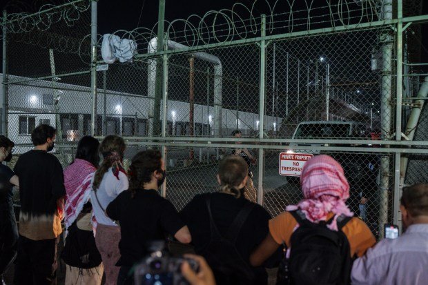 Protesters link hands at the gates of the Delaney Hall Detention Facility to prevent vehicles from exiting during protests over federal immigration enforcement raids on Thursday, June 12, 2025, in Newark, N.J. (AP Photo/Olga Fedorova)