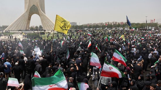 People attend the funeral procession of Iranian military commanders, nuclear scientists and others killed in Israeli strikes in Tehran.(Reuters)