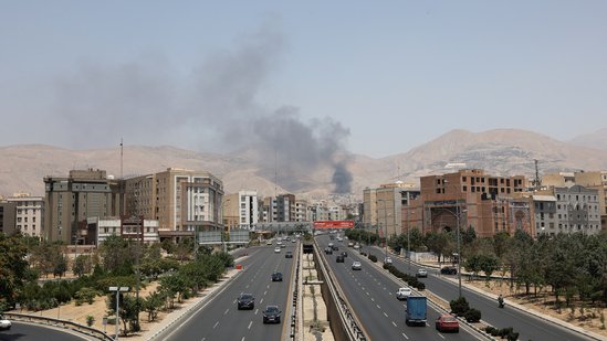 Smoke rises following what Iran says was an Israeli attack on Sharan Oil depot in Tehran.(Reuters)