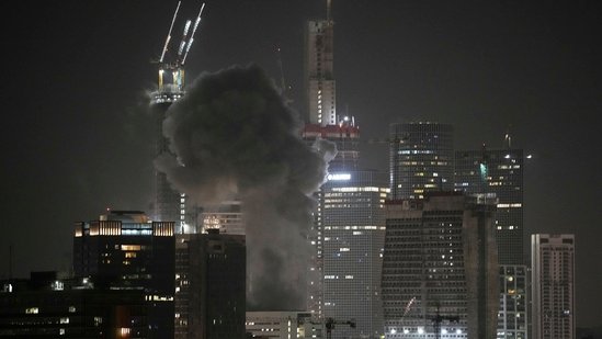 Smoke billows after a projectile hit a building in Tel Aviv after Iran launched multiple waves of missile attacks on Saturday.(AP)