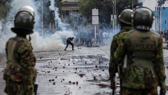 A protester ducks a teargas canister in downtown Nairobi on June 25, 2025, during a protest.(AFP)