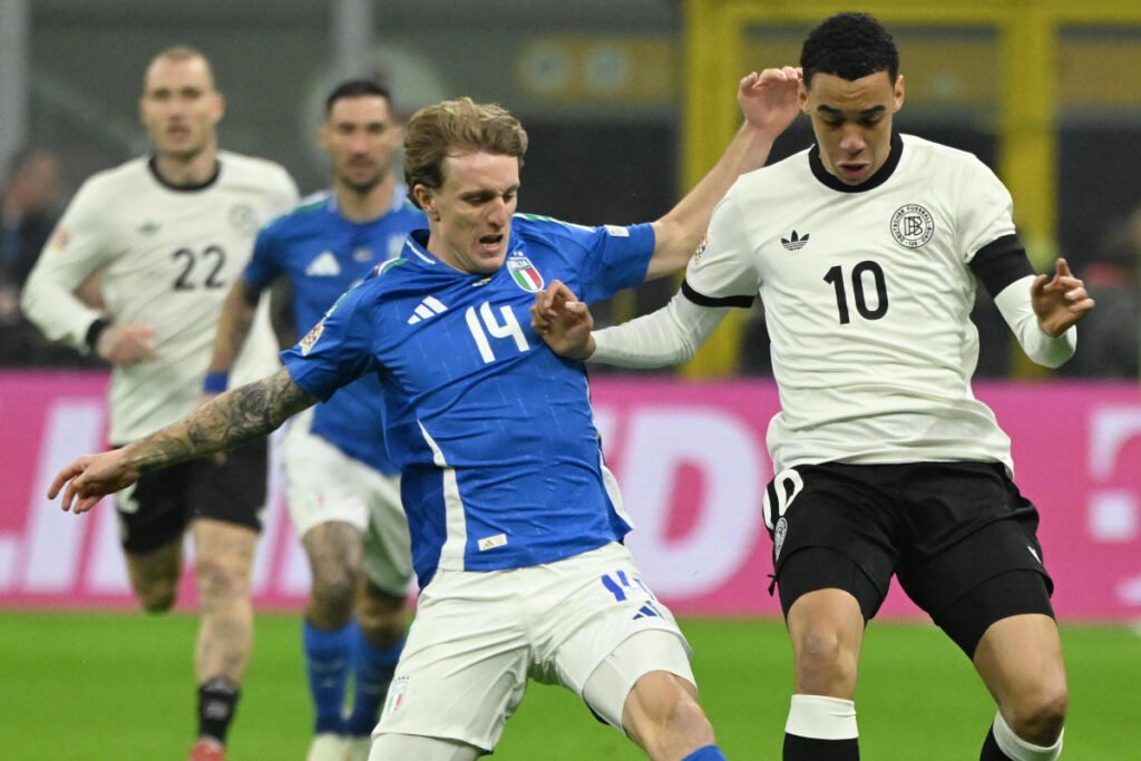 epa11976821 Germany’s midfielder Jamal Musiala (R) and Italy’s midfielder Nicolo Rovella struggle for the ball during the UEFA Nations League quarterfinals first leg soccer match between Italy and Germany at the Giuseppe Meazza Stadium in Milan, Italy, 20 March 2025. EPA-EFE/Daniel Dal Zennaro