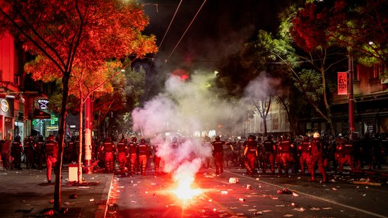 Law enforcement officers take position as a fire burns nearby during an anti-government protest demanding snap elections, in Belgrade, Serbia(REUTERS)