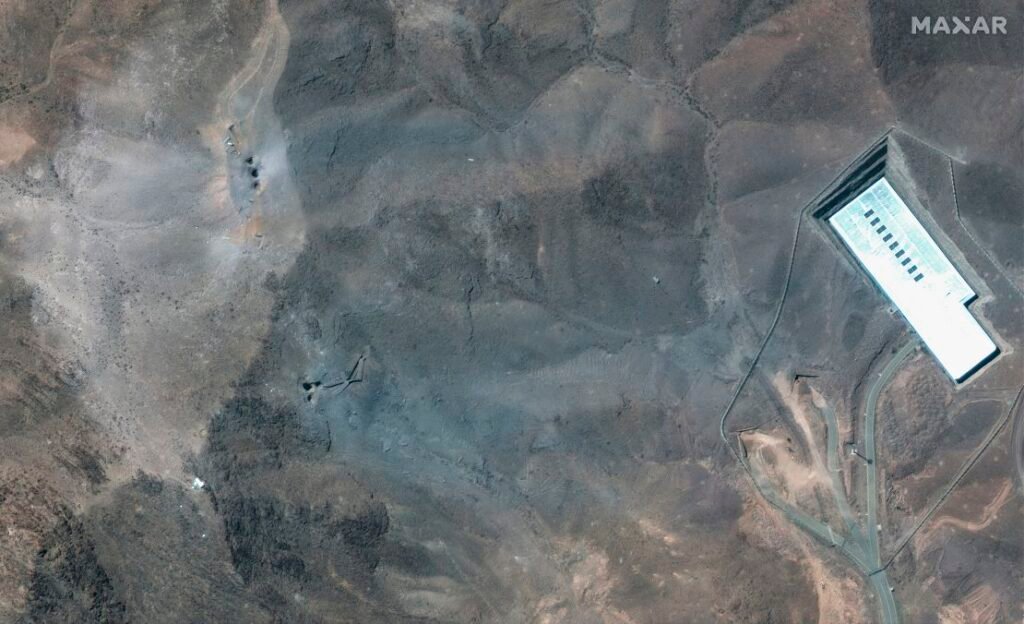 This satellite image provided by Maxar Technologies shows a closer view of craters and ash on a ridge at Fordow enrichment facility in Iran after US strikes.
