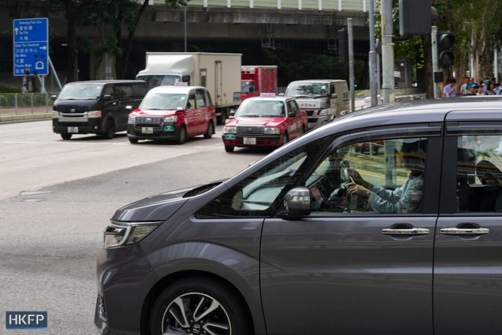 Cars drive in Hong Kong in June, 2025. Photo: Kyle Lam/HKFP.