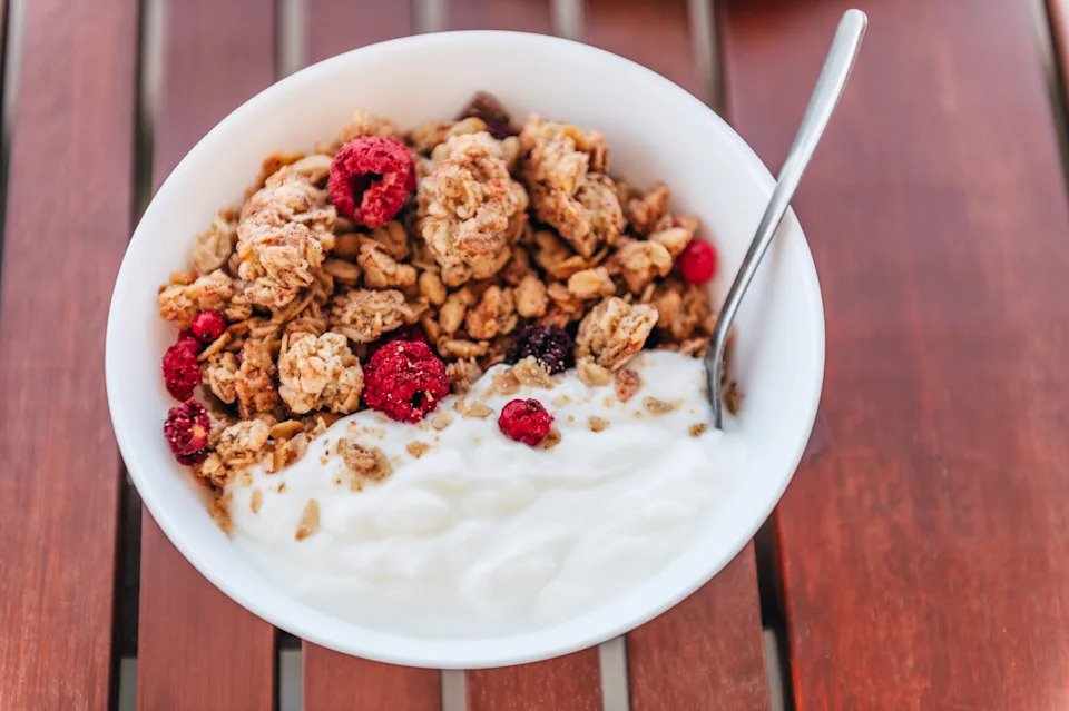 Healthy summer breakfast. Granola with dairy free yogurt and dry berries.
