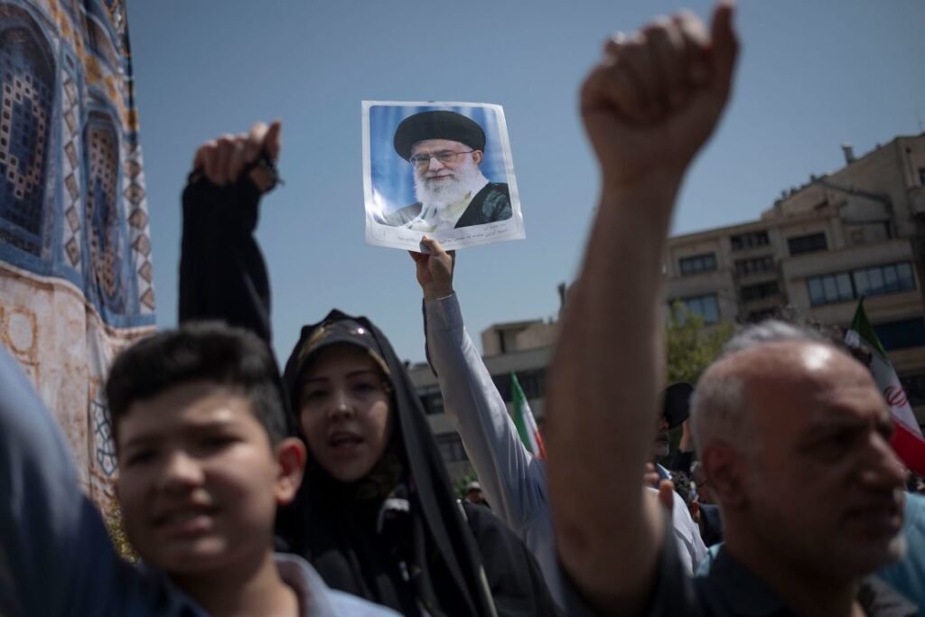 Iranian worshippers shout anti-US and anti-Israel slogans while one of them holds up a portrait of Iran's Supreme Leader Ayatollah Ali Khamenei during a rally to condemn Israeli attacks on Iran, in Tehran on Friday.