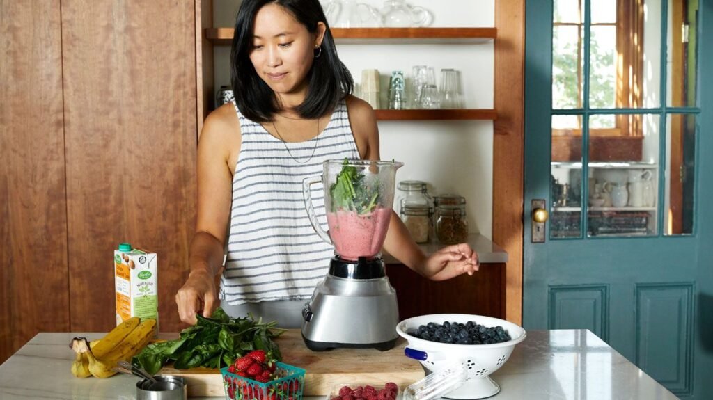 Female making a smoothie in the kitchen