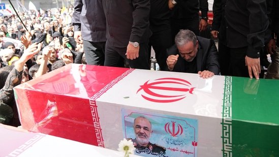 This handout picture provided by the Iranian foreign ministry shows Iran's Foreign Minister Abbas Araghchi mourning next to the coffin of Iranian Revolutionary Guards commander Hossein Salami, who was killed during Israeli strikes.(AFP)