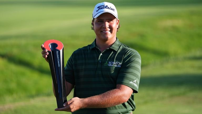 Aldrich Potgieter, of South Africa poses with the trophy after winning a playoff during the final round of the Rocket Classic
