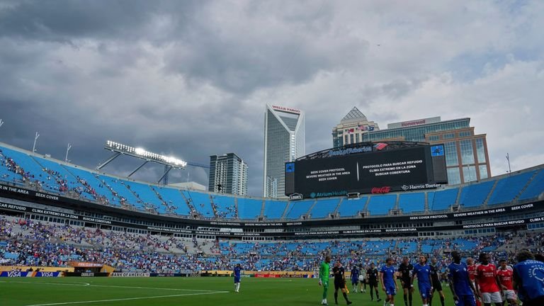 Players walk off the field for a weather delay during the Club World Cup round of 16 soccer match between Benfica and Chelsea in Charlotte, N.C., Saturday, June 28, 2025. (AP Photo/Chris Carlson)