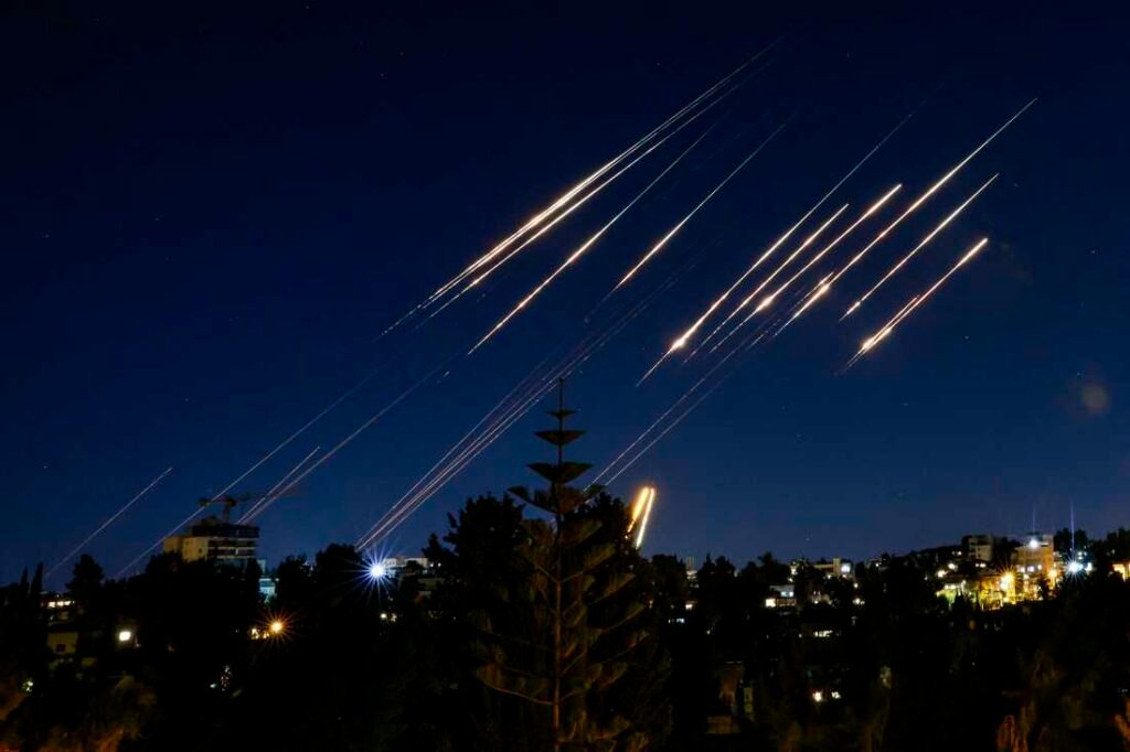 Missiles fired from Iran are pictured in the night sky over Jerusalem on June 14, 2025 as Israel and Iran exchanged fire a day after Israel unleashed an unprecedented aerial bombing campaign that Iran said hit its nuclear facilities, "martyred" top commanders and killed dozens of civilians.