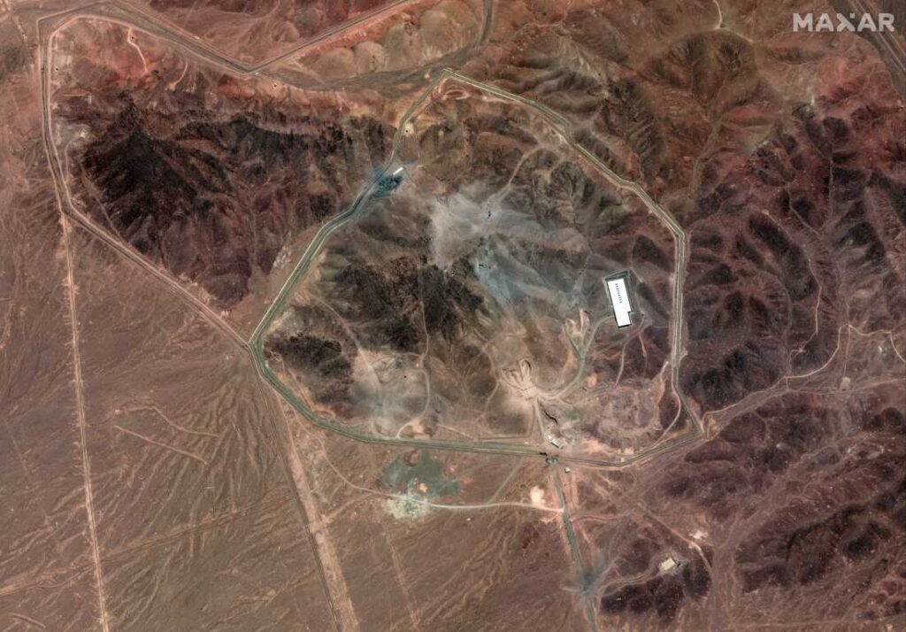 A satellite photo of Iran's Fordo fuel enrichment facility taken on 24 June shows debris (grey) from a U.S. strike employing several bunker-busting weapons. The Israeli Air Force destroyed additional roads and surface facilities in a subsequent strike.