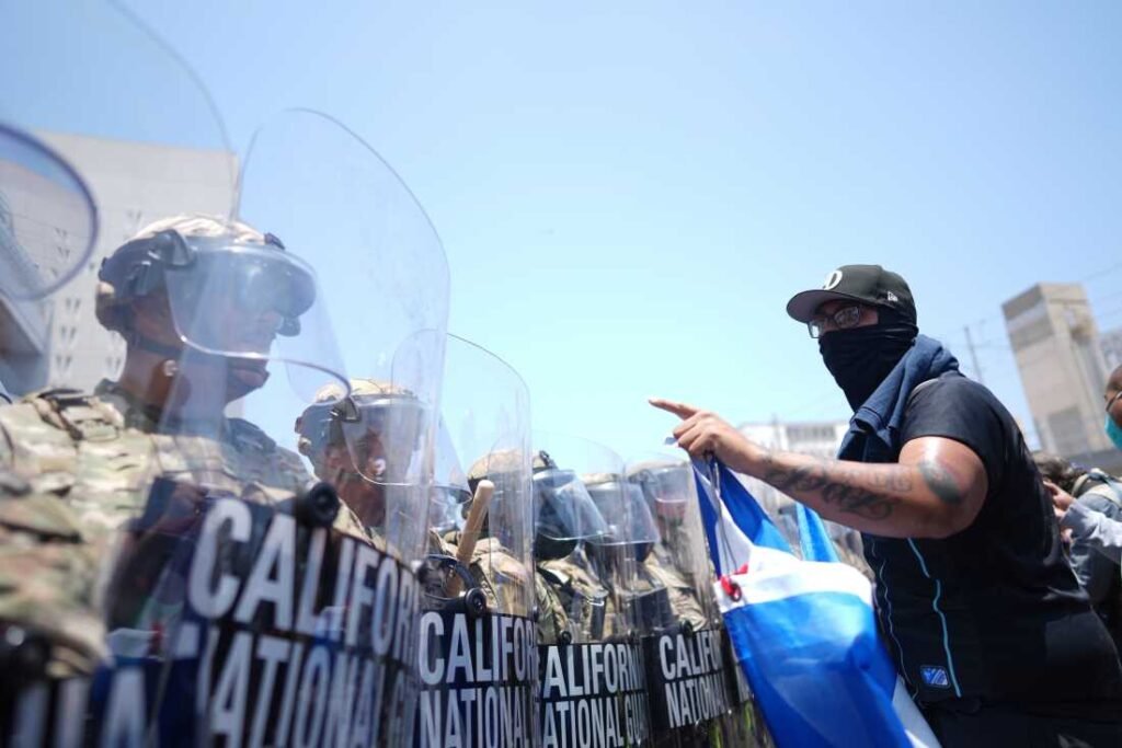 A protester confronts a line of U.S. National Guard in the metropolitan detention center of downtown Los Angeles on Sunday.