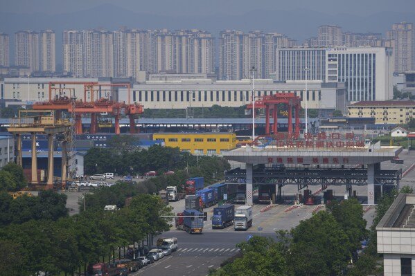 Trucks leave the Chongqing Railway Container Terminal Station after loading their containers, in southwest China's Chongqing Municipality on Tuesday, May 20, 2025. (AP Photo/Andy Wong)
