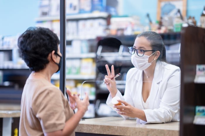 Pharmacist talking to patient.