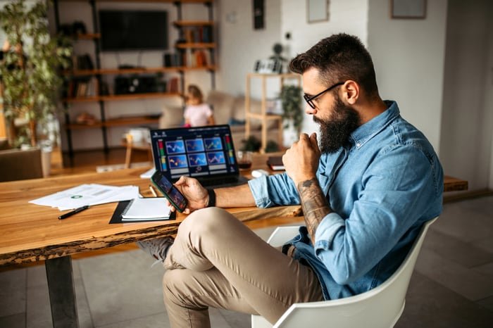 A person analyzing investments on a mobile device.