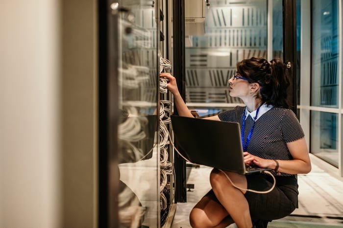 Cloud computing IT technician in server. room.