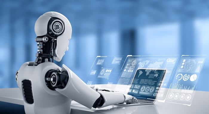 Robot working on a laptop.