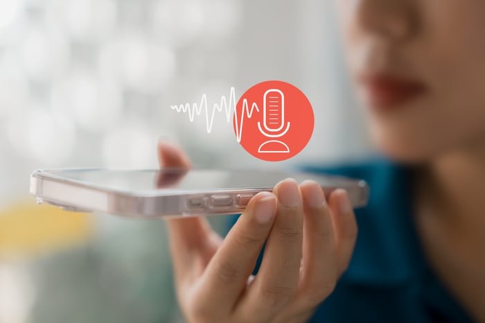 A person speaking via an AI app on a smartphone.