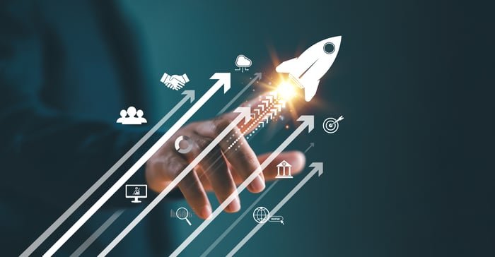 A person pointing at a rocket-ship icon.
