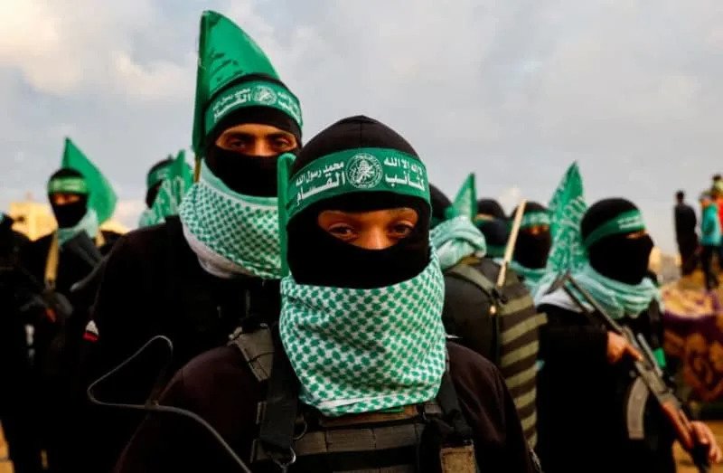 Palestinian Hamas terrorists keep guard on the day Hamas handed over deceased hostages in Khan Younis in the southern Gaza Strip February 20, 2025. (credit: REUTERS/Hatem Khaled/File Photo)