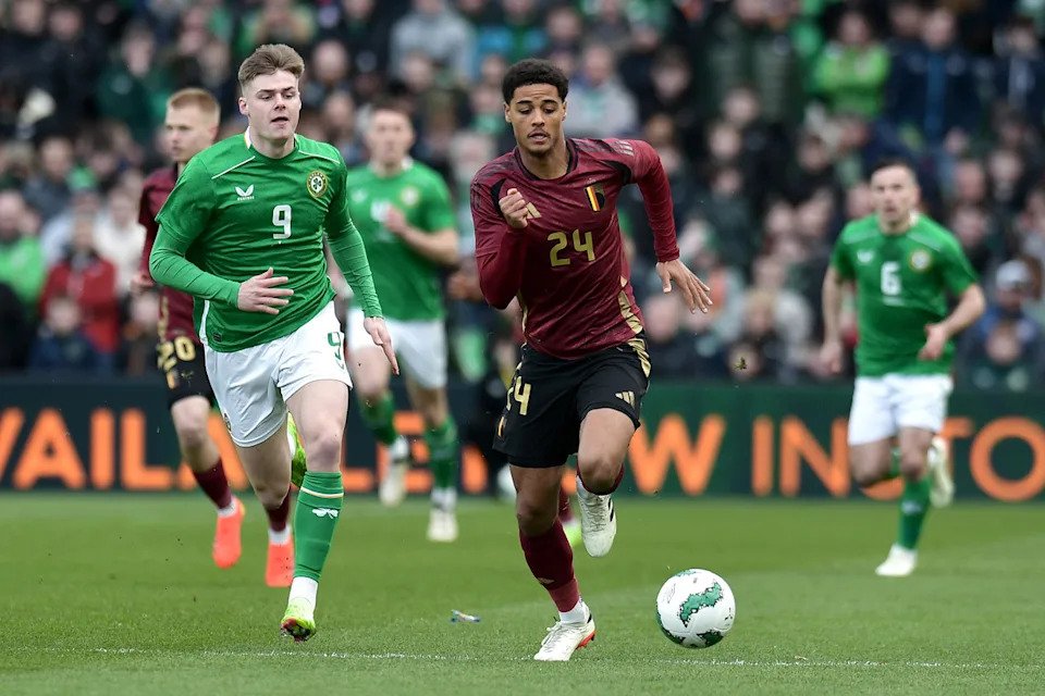 DUBLIN, IRELAND – MARCH 23: Koni De Winter of Belgium runs with the ball whilst under pressure from Evan Ferguson of Republic of Ireland during the international friendly match between Republic of Ireland and Belgium at Aviva Stadium on March 23, 2024 in Dublin, Ireland. (Photo by Charles McQuillan/Getty Images)