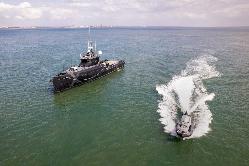 A ship and small boat.