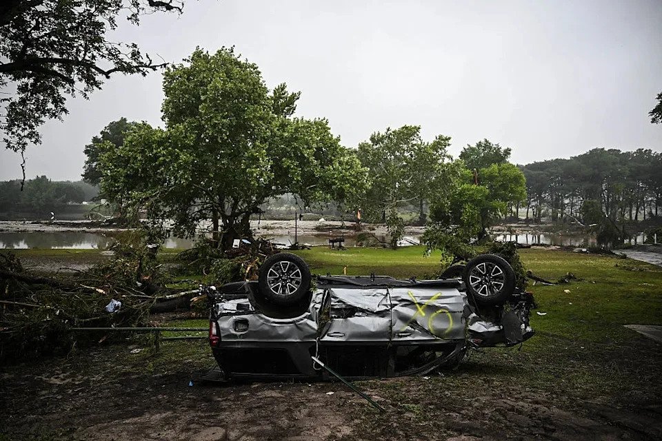 A damaged and overturned car is seen after severe flash flooding in Hunt, Texas, on July 5, 2025.