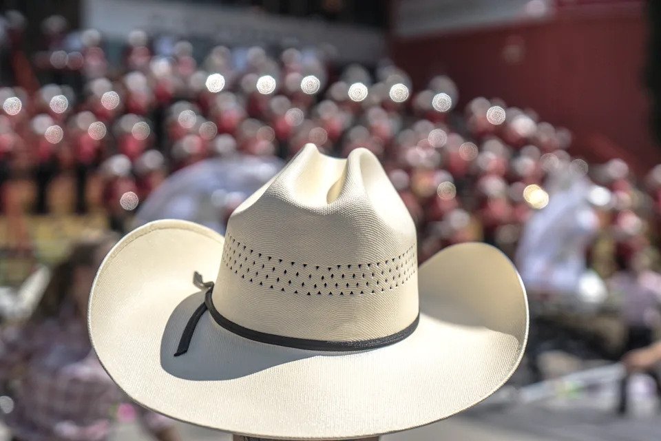 A cowboy hat at the Calgary Stampede with the music band playing in the background