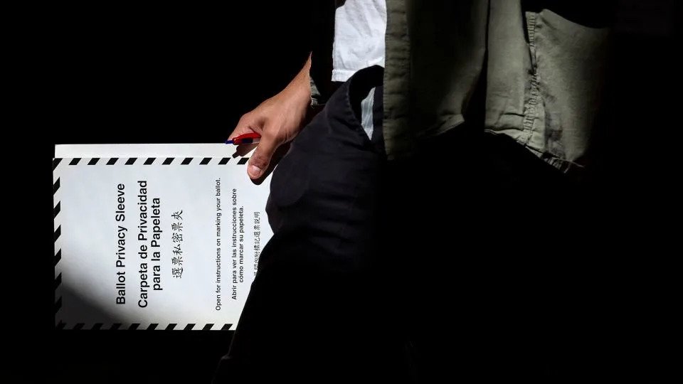 A voter carries a ballot while voting in the primary election, which includes the race for the Democratic candidate for New York City mayor in the November's election, in New York's Brooklyn borough on June 24. - Brendan McDermid/Reuters