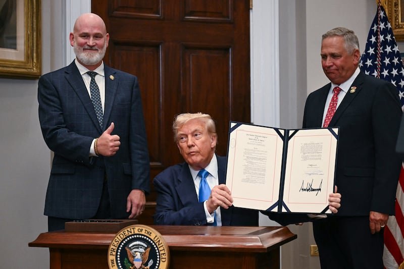 President Donald Trump, joined by Rep.s Derrick Van Orden (R-WI) and Mike Bost (R-IL) signs the VA Home Loan Program Reform Act.