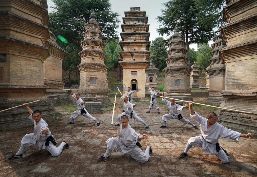 Shaolin monks practise martial arts at the temple’s Pagoda Forest. Photo: Xinhua