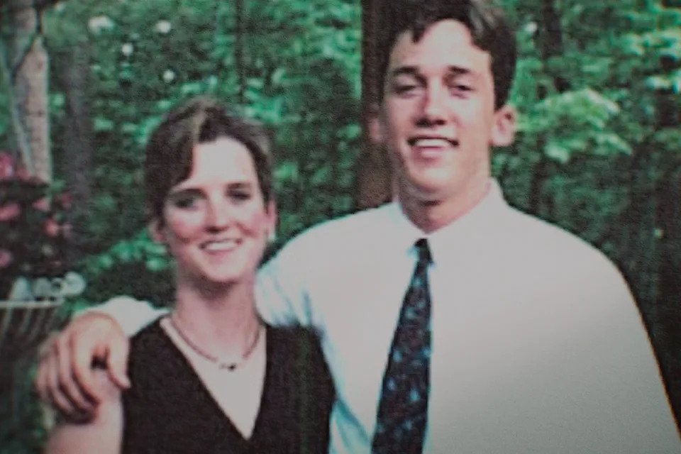 Grainy photo of Amy Bradley standing arm in arm with her brother, Brad.