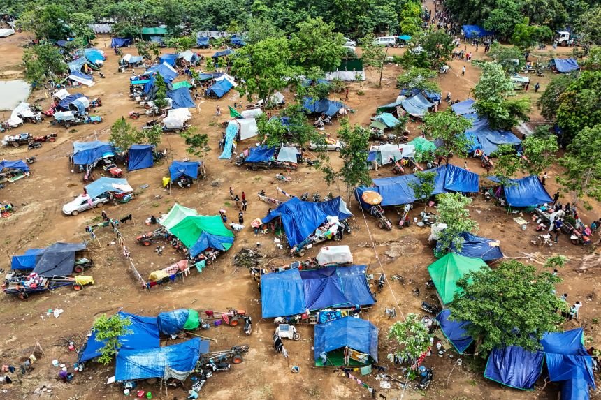 An aerial view shows people, who fled their homes near the border area between Cambodia and Thailand, taking shelter near a pagoda in Oddar Meanchey province on July 26, 2025.