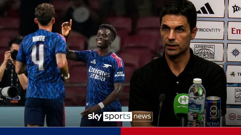 Arsenal's Bukayo Saka, right celebrates a goal near teammates Arsenal's Benjamin White and Arsenal's Martin Odegaard during a friendly match against AC Milan for the Singapore Festival of