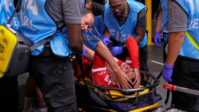 Bayern Munich's Jamal Musiala is taken off the field after an injury during the Club World Cup quarterfinal soccer match against PSG