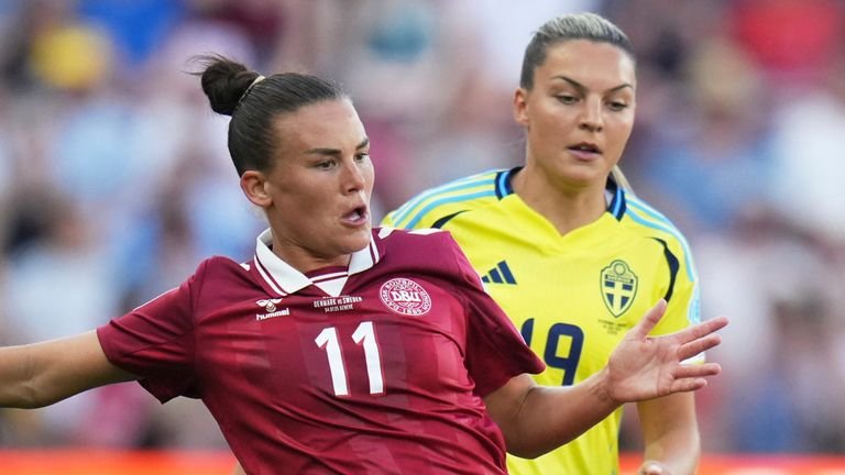 Denmark's Katrine Veje challenges for the ball with Sweden's Johanna Rytting Kaneryd during Euro 2025
