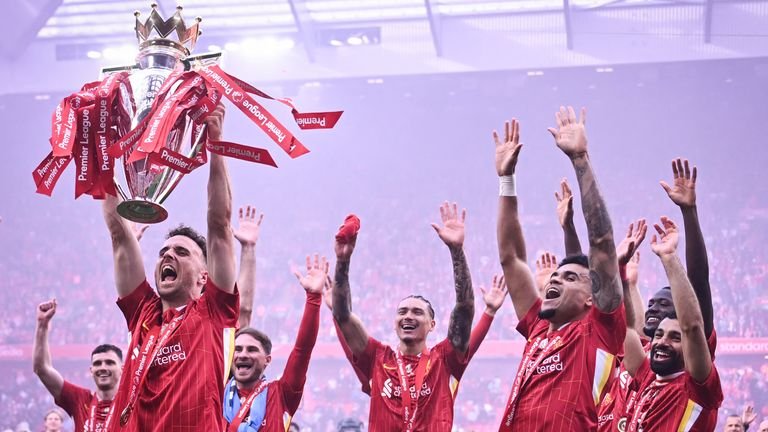 Diogo Jota lifts the Premier League trophy amid Liverpool's celebrations at the end of the 2024/25 season