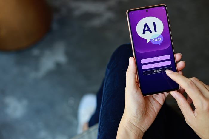Person holding a smartphone with the term AI chat written on the screen.