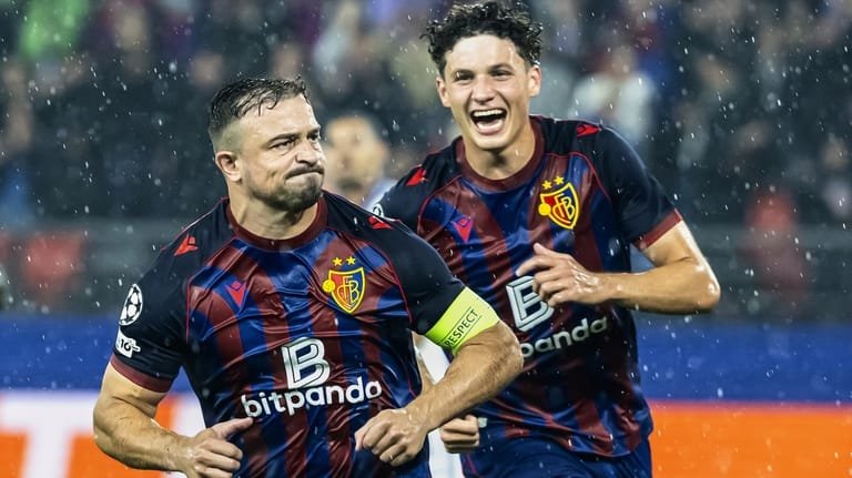 Basel's Xherdan Shaqiri, left, celebrates with teammates after scoring agoal...