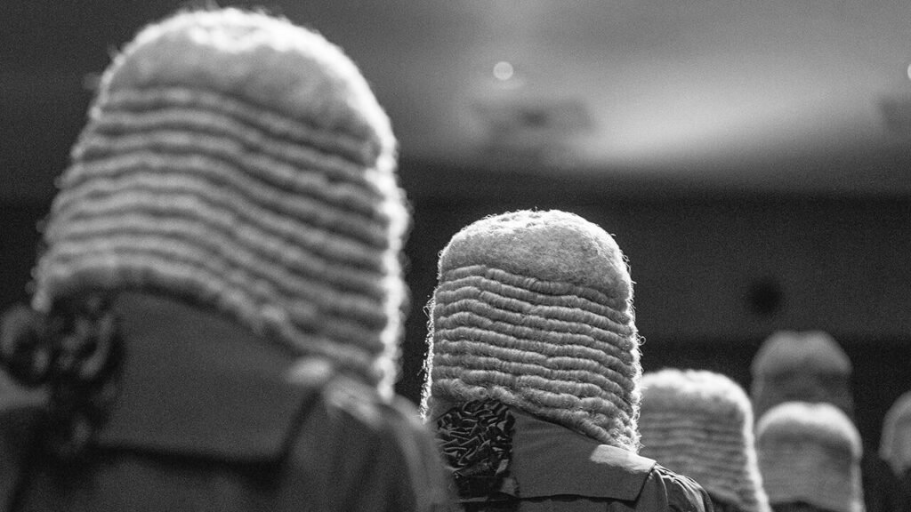 Judges wearing wigs and robes.