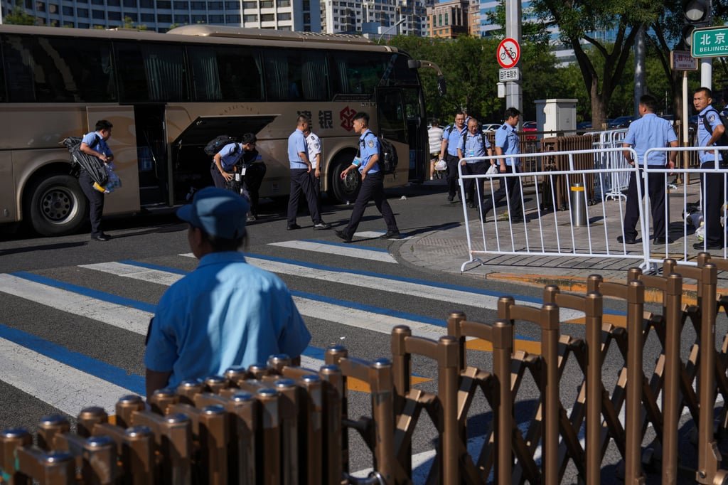 Policemen disembark from a bus in central Beijing on Saturday to prepare for a rehearsal for a military parade next month. Photo: AP