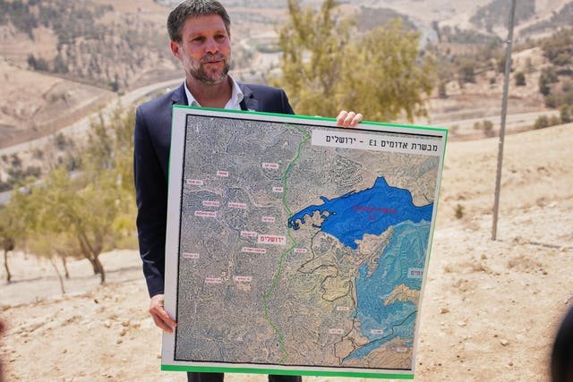 Israeli finance minister Bezalel Smotrich holds a map showing the E1 settlement project