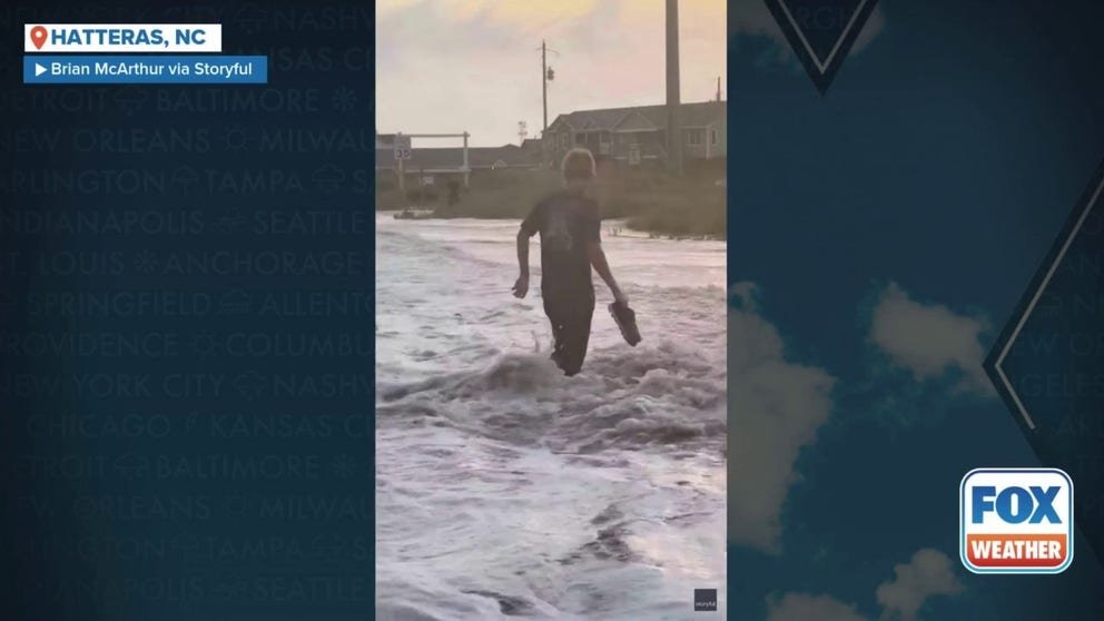 A North Carolina man was hit by a strong wave from Hurricane Erin as he stood on a sand dune in Hatteras, North Carolina, on Wednesday.